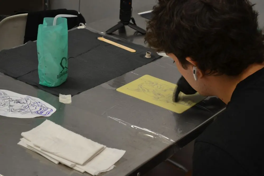 Alumno pasando un diseño a piel sintética